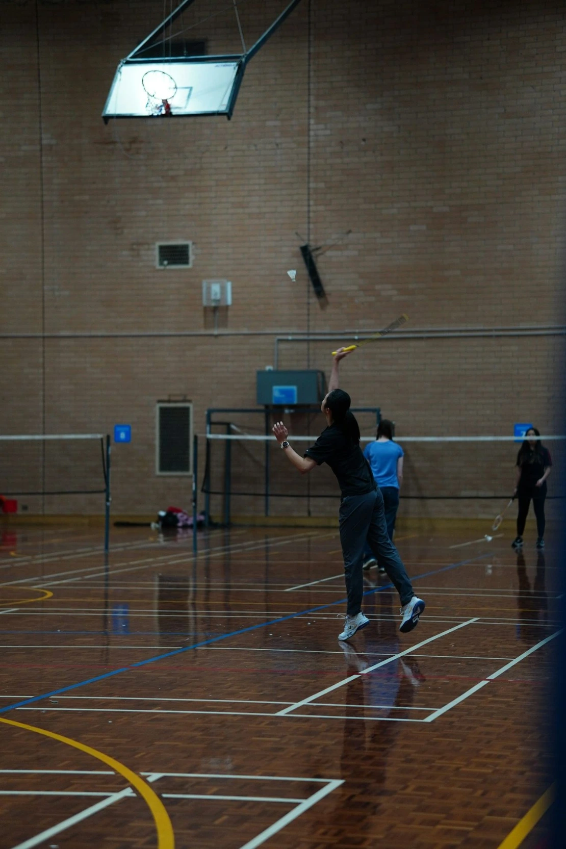 A group of people playing a game of badminton
